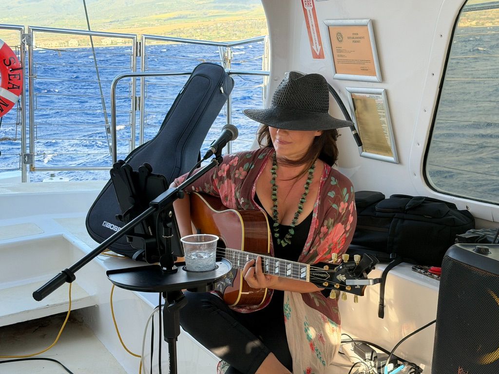 Moody portrait of Kris Bradley wearing a hat on a boat.