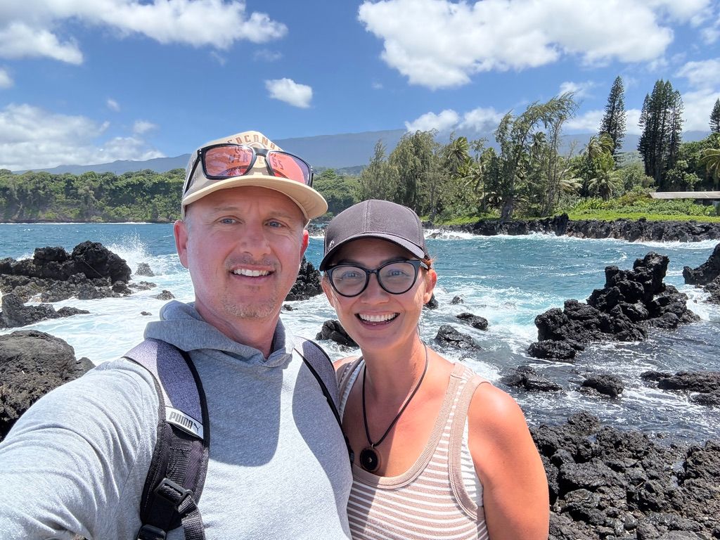 Kris Bradley and her husband along Maui's rocky coastline.